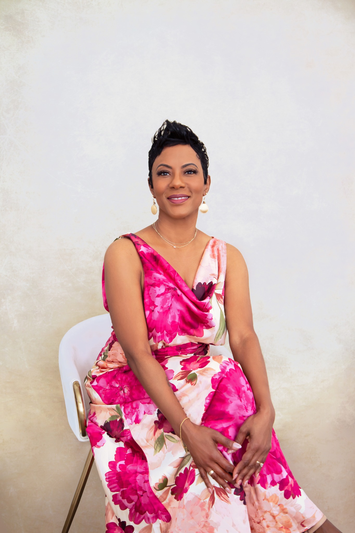Tanya Smith seated in a floral dress